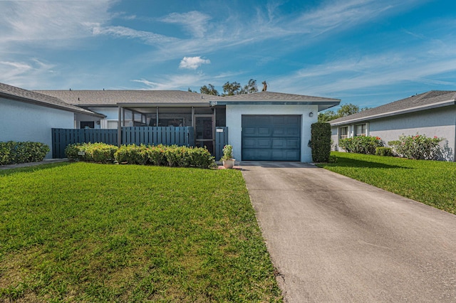 ranch-style home featuring an attached garage, fence, concrete driveway, stucco siding, and a front yard