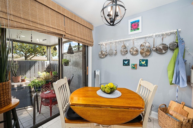 dining area featuring a notable chandelier and light tile patterned floors