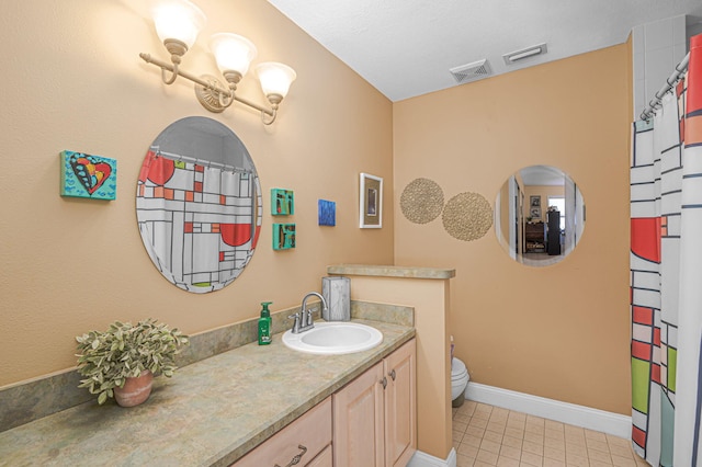 bathroom featuring baseboards, visible vents, vanity, and toilet