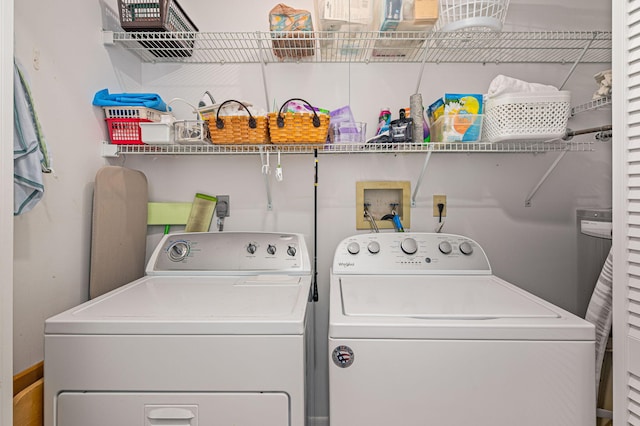 clothes washing area featuring washing machine and dryer and laundry area