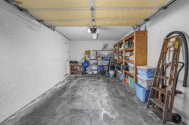 garage featuring a garage door opener and a textured wall