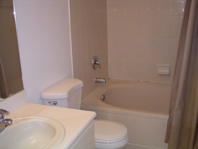 full bathroom featuring vanity, toilet, and shower / bath combination with curtain