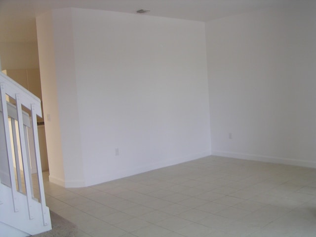 unfurnished room with light tile patterned floors