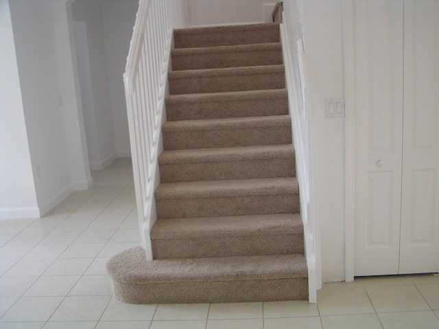 stairway featuring tile patterned flooring