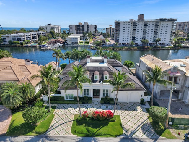 drone / aerial view featuring a view of city and a water view