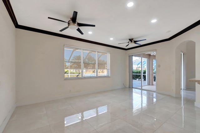 spare room with baseboards, ornamental molding, arched walkways, and recessed lighting