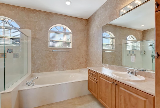 full bath with tile patterned flooring, a garden tub, recessed lighting, vanity, and tiled shower