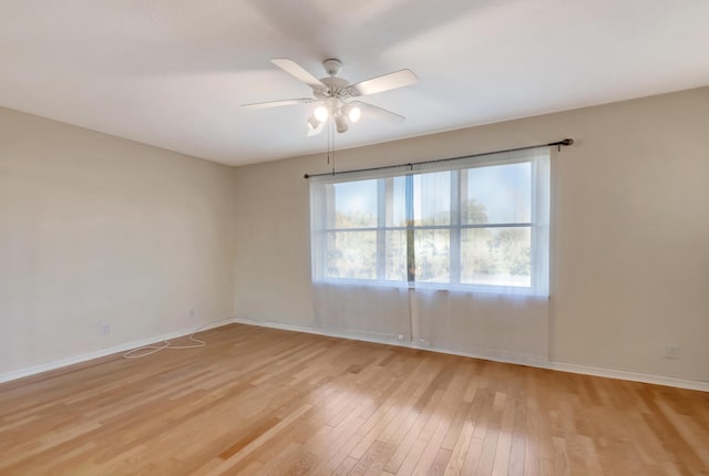 empty room with light wood-style floors, ceiling fan, and baseboards