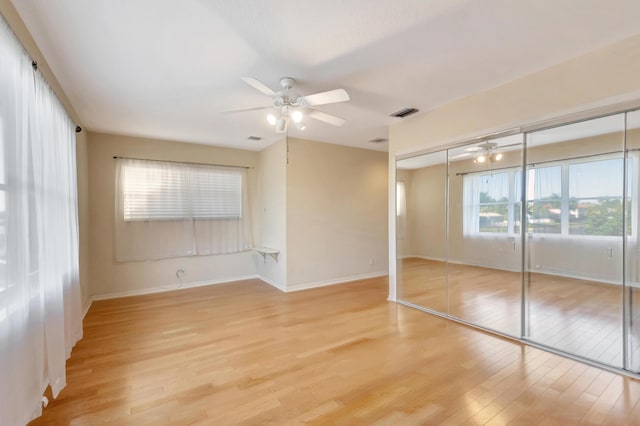 unfurnished bedroom with visible vents, a ceiling fan, baseboards, a closet, and light wood-type flooring