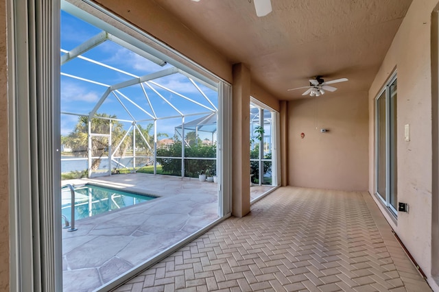 interior space featuring a ceiling fan and a water view