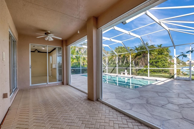 outdoor pool featuring a lanai, a patio, and ceiling fan