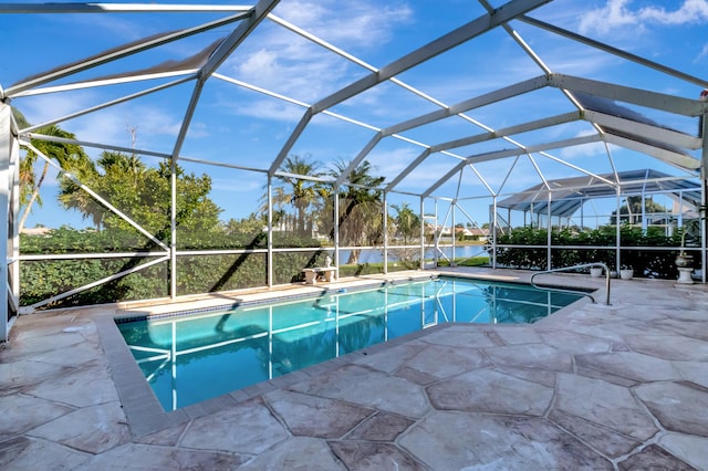 pool with a lanai and a patio area