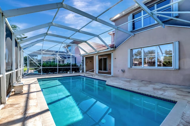 outdoor pool with a lanai and a patio