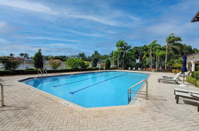 pool with fence and a patio