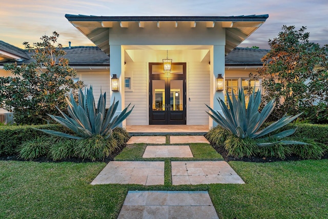 property entrance with french doors and a yard