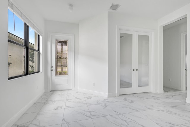 interior space with visible vents and french doors