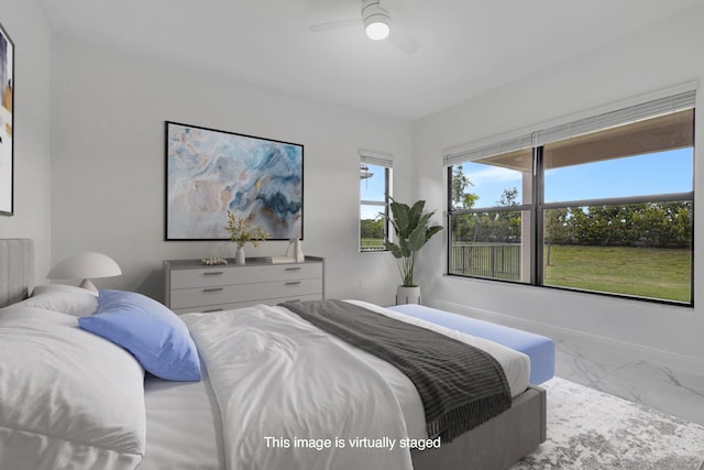 bedroom featuring ceiling fan, baseboards, and marble finish floor