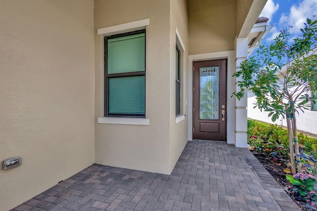 view of exterior entry with stucco siding