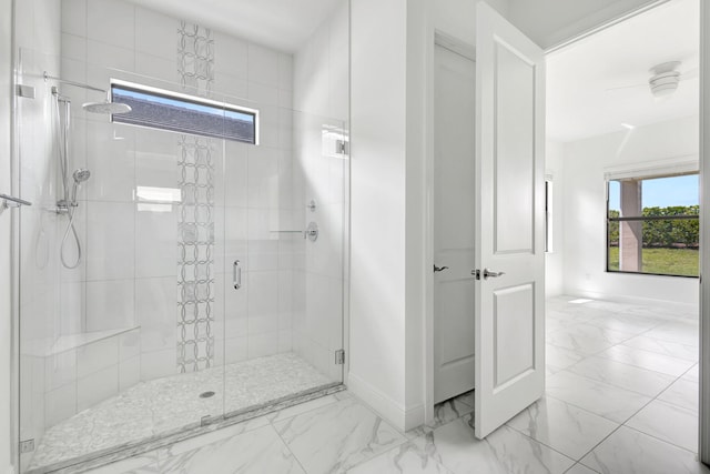 bathroom featuring a stall shower, marble finish floor, and baseboards