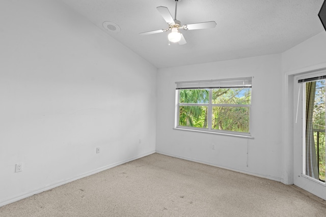 1820 SE Hideaway Cir Unit 1820, Port Saint Lucie, FL 34952 - unfurnished room featuring a ceiling fan, carpet flooring, vaulted ceiling, and baseboards