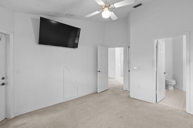 1820 SE Hideaway Cir Unit 1820, Port Saint Lucie, FL 34952 - unfurnished bedroom with carpet floors, ceiling fan, ensuite bathroom, baseboards, and visible vents
