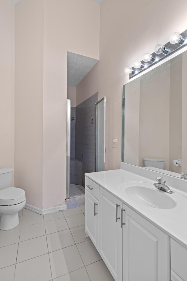 1820 SE Hideaway Cir Unit 1820, Port Saint Lucie, FL 34952 - bathroom with a stall shower, baseboards, toilet, tile patterned floors, and vanity