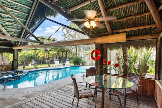 1820 SE Hideaway Cir Unit 1820, Port Saint Lucie, FL 34952 - view of swimming pool featuring a pool with connected hot tub, a wooden deck, and glass enclosure