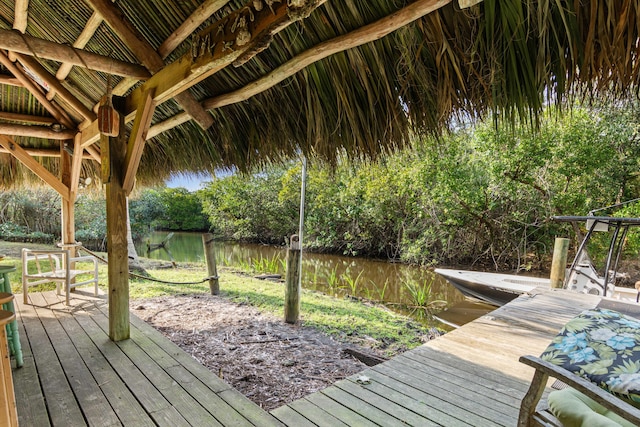 1820 SE Hideaway Cir Unit 1820, Port Saint Lucie, FL 34952 - wooden terrace featuring a dock and a water view