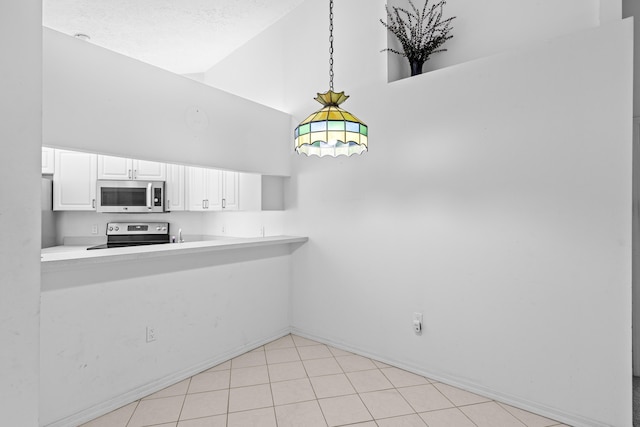 1820 SE Hideaway Cir Unit 1820, Port Saint Lucie, FL 34952 - interior space featuring pendant lighting, white cabinets, appliances with stainless steel finishes, light countertops, and high vaulted ceiling