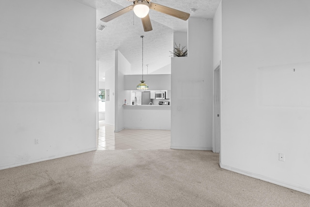 1820 SE Hideaway Cir Unit 1820, Port Saint Lucie, FL 34952 - unfurnished living room with a textured ceiling, carpet flooring, visible vents, ceiling fan, and high vaulted ceiling