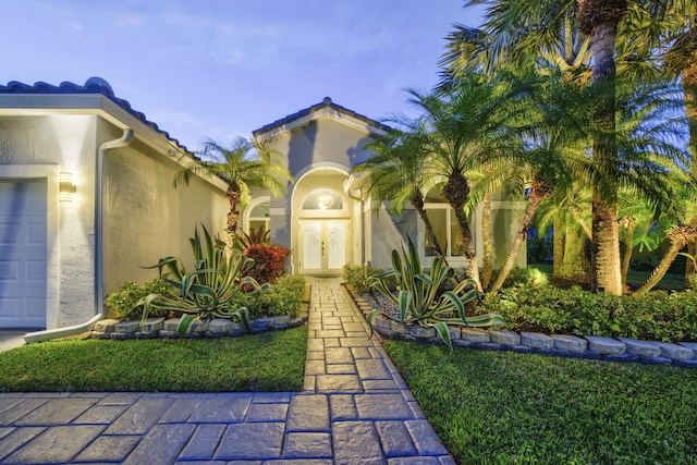 exterior space with a garage and a lawn