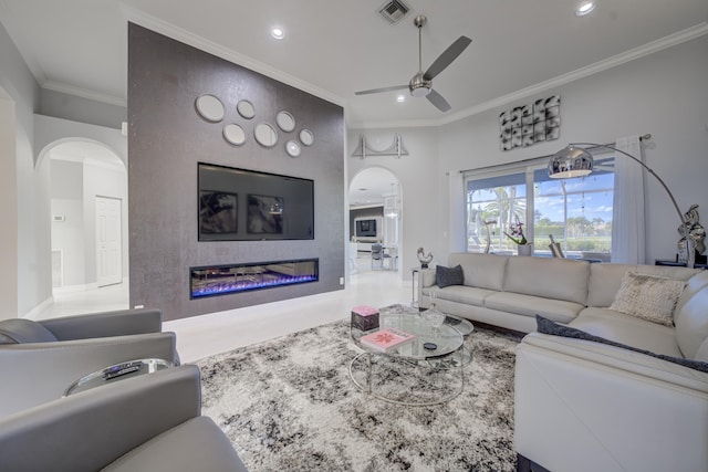 living room featuring ceiling fan and crown molding