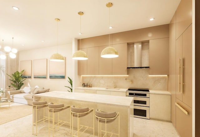 kitchen featuring tasteful backsplash, light countertops, a sink, wall chimney range hood, and double oven range