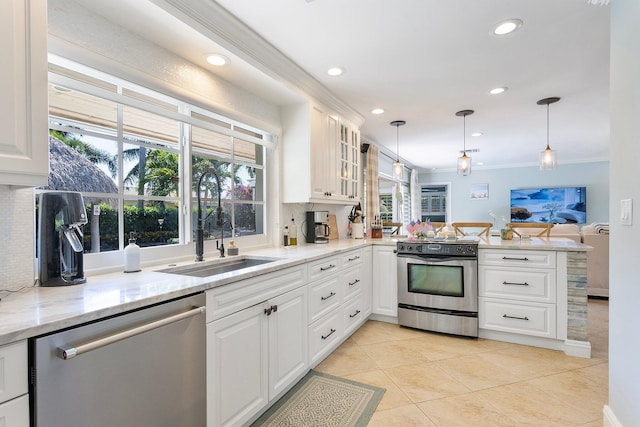 kitchen with crown molding, appliances with stainless steel finishes, a peninsula, white cabinetry, and a sink