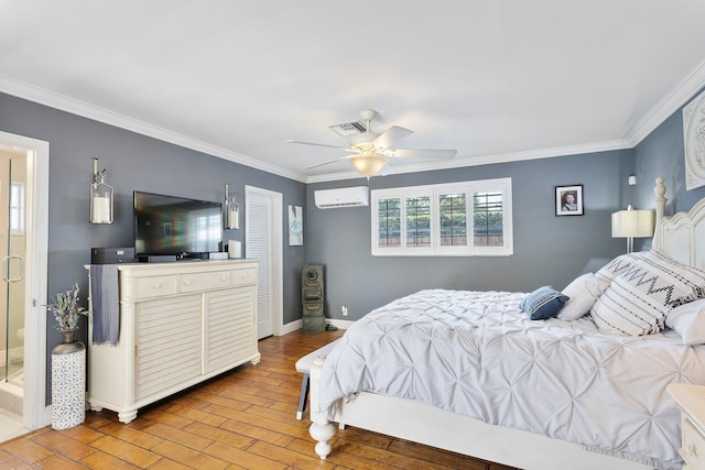 bedroom with a wall mounted air conditioner, visible vents, ornamental molding, light wood-style floors, and baseboards