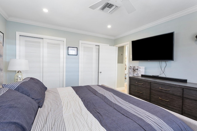 bedroom featuring a ceiling fan, visible vents, recessed lighting, multiple closets, and crown molding
