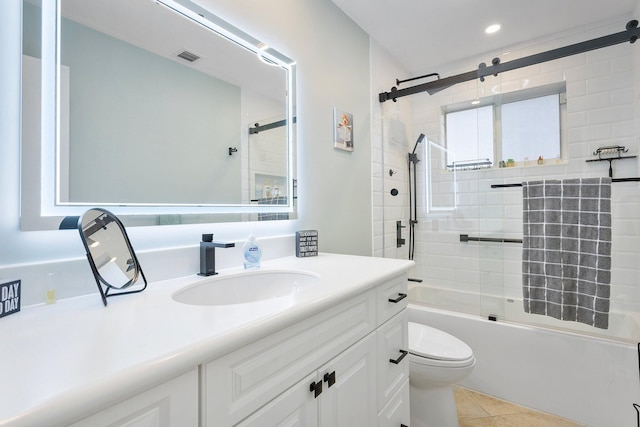 full bathroom with visible vents, toilet, tile patterned floors, combined bath / shower with glass door, and vanity