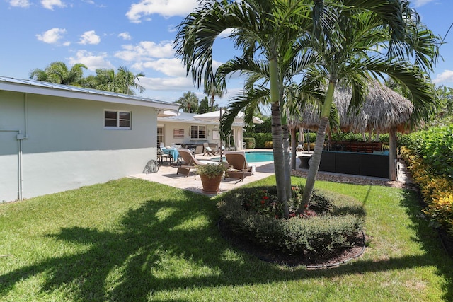 view of yard featuring a patio area and an outdoor pool