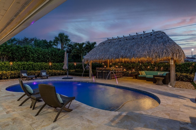 view of pool with outdoor lounge area, a patio area, outdoor dry bar, and a gazebo