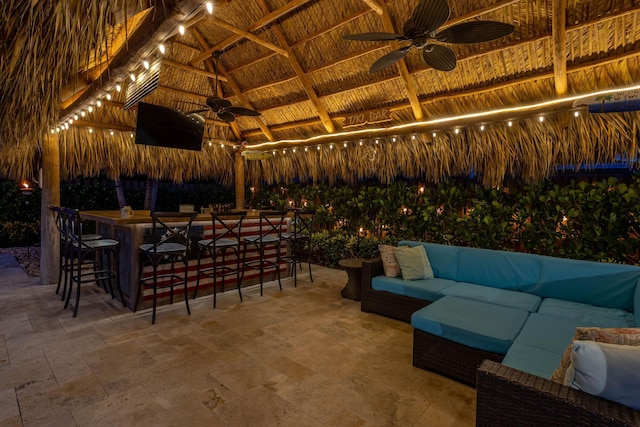 view of patio / terrace with an outdoor hangout area, outdoor dry bar, a ceiling fan, and a gazebo