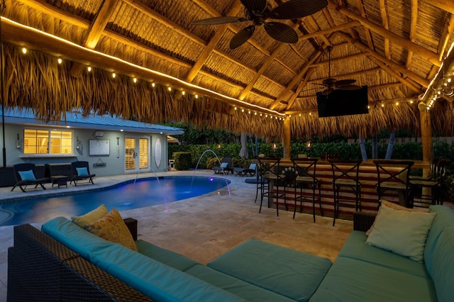 outdoor pool with french doors, a patio, outdoor lounge area, a gazebo, and a ceiling fan