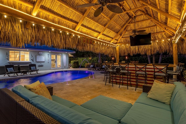 outdoor pool with a gazebo, an outdoor hangout area, french doors, a patio area, and outdoor dry bar