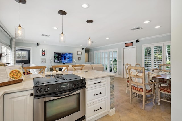 kitchen featuring stainless steel range with electric stovetop, open floor plan, white cabinetry, and hanging light fixtures