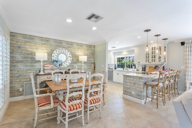 dining area featuring recessed lighting, visible vents, an accent wall, and crown molding