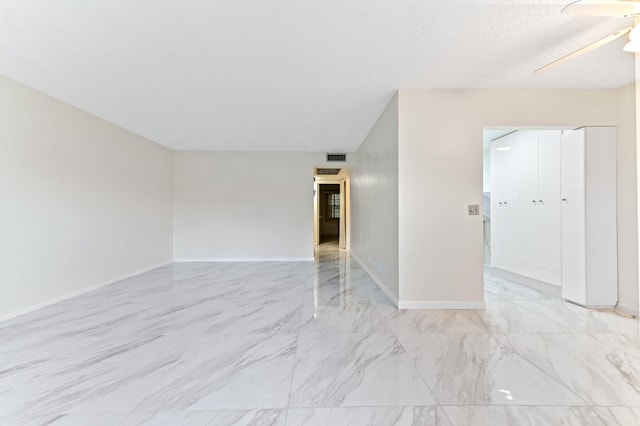 spare room with a textured ceiling