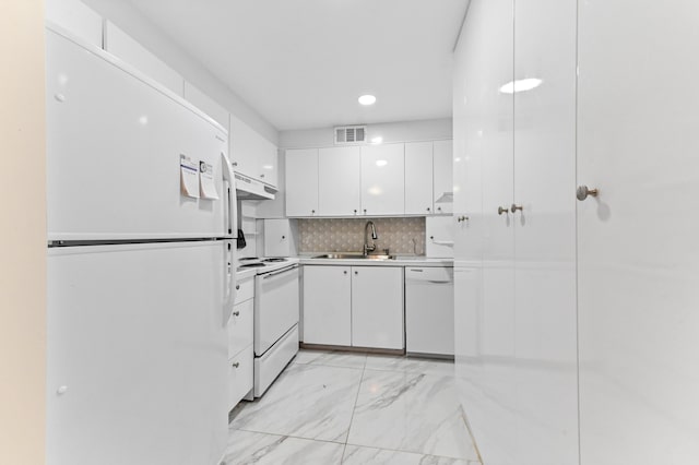 1024 Ellesmere B, Deerfield Beach, FL 33442 - kitchen featuring white appliances, sink, backsplash, and white cabinets