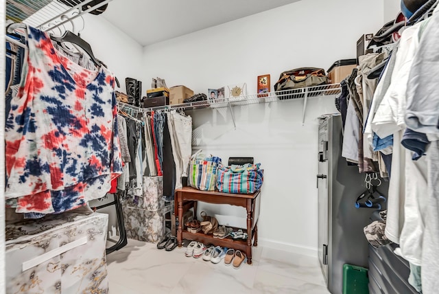 spacious closet with marble finish floor