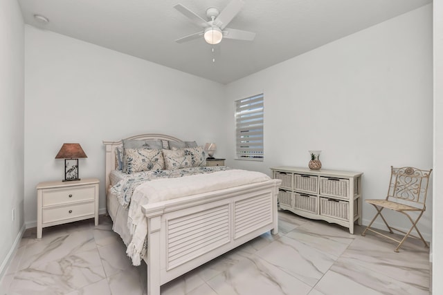 bedroom featuring marble finish floor, ceiling fan, and baseboards