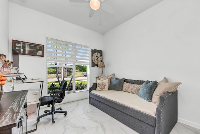 office with a ceiling fan, marble finish floor, and baseboards