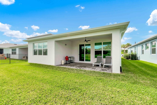 back of house featuring a patio area, ceiling fan, fence, and a yard